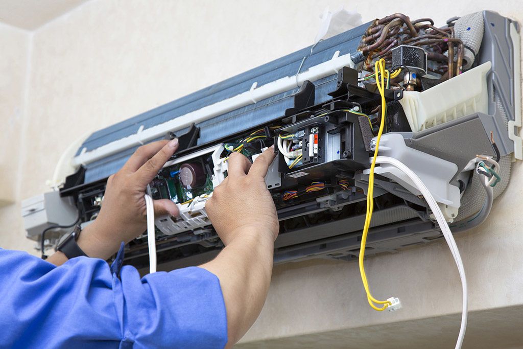 HVAC technician repairing air conditioner